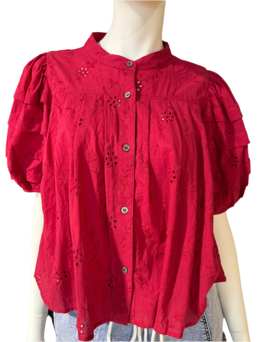 Red blouse on a mannequin with a blurred background